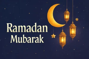 Warm Ramadan evening scene with mosque, lanterns, and an English greeting card on a table.